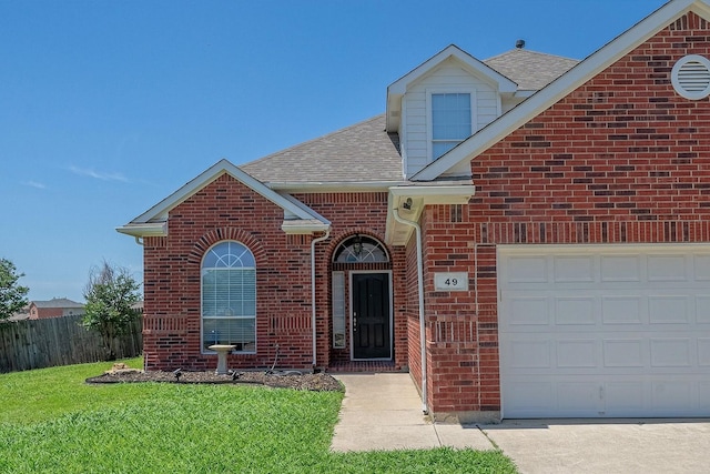 view of property with a front lawn and a garage