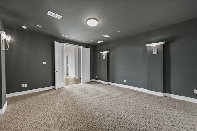 unfurnished room featuring light carpet