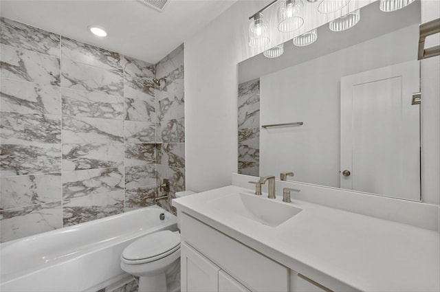 full bathroom featuring toilet, vanity, and tiled shower / bath