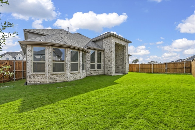 rear view of house with a yard