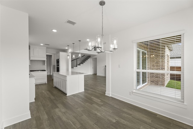 unfurnished dining area featuring dark hardwood / wood-style flooring and a notable chandelier