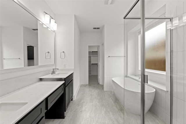 bathroom with vanity, hardwood / wood-style floors, and shower with separate bathtub