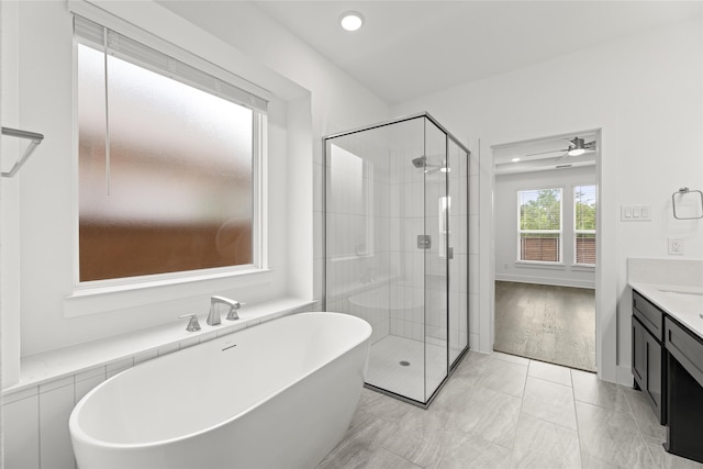 bathroom featuring independent shower and bath, ceiling fan, and vanity