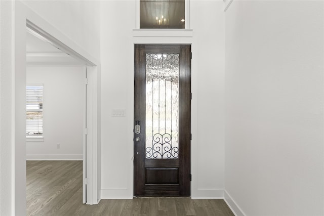 entryway with baseboards and wood finished floors