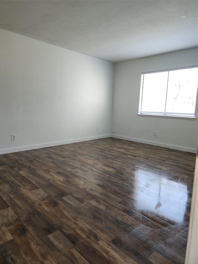 empty room with dark wood-type flooring