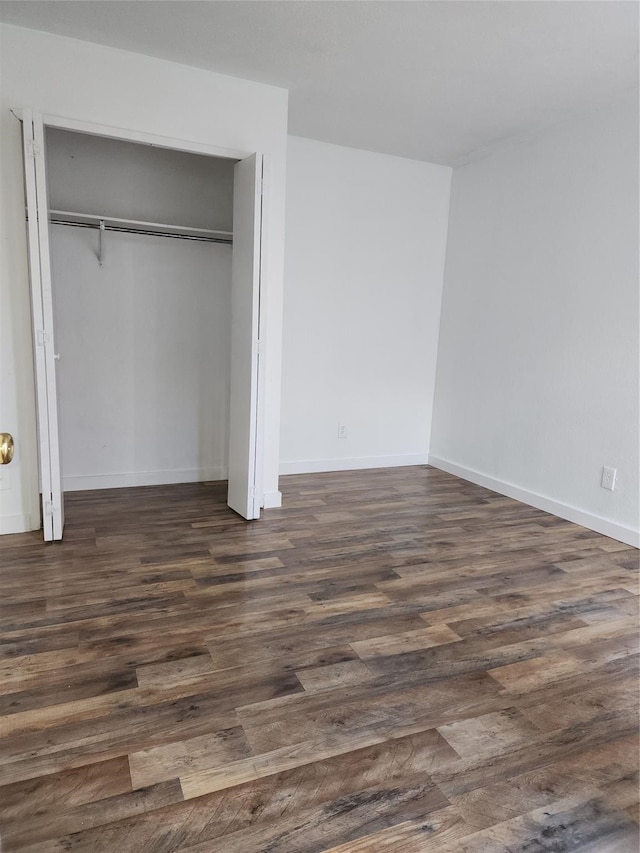 unfurnished bedroom featuring dark hardwood / wood-style flooring