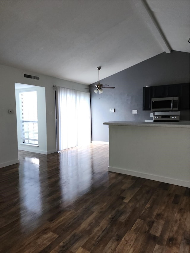 unfurnished living room with dark wood-type flooring, ceiling fan, and lofted ceiling with beams