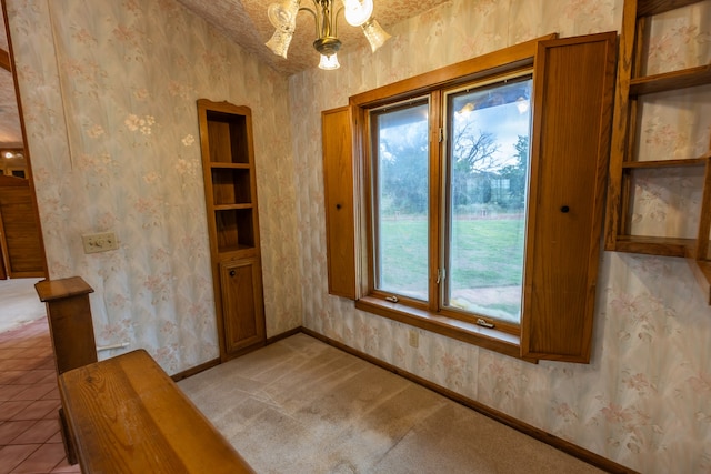 unfurnished dining area with tile flooring and a chandelier