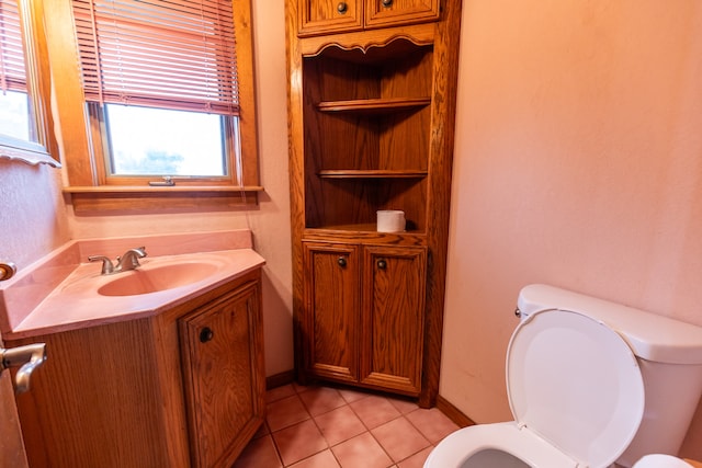 bathroom with tile floors, toilet, and vanity