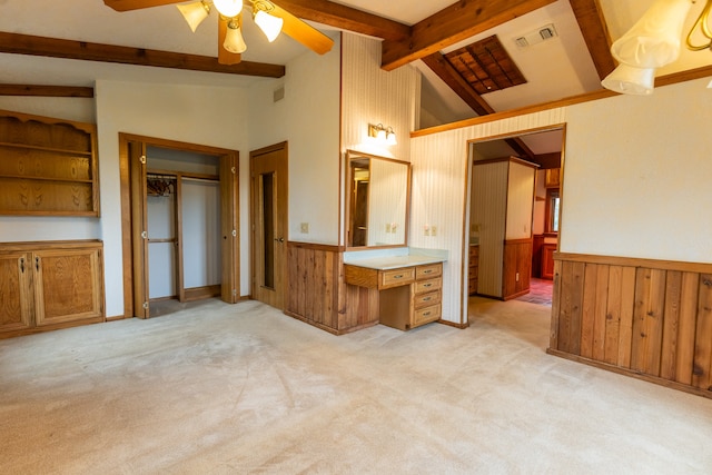 unfurnished bedroom featuring ceiling fan, a closet, light carpet, beamed ceiling, and high vaulted ceiling