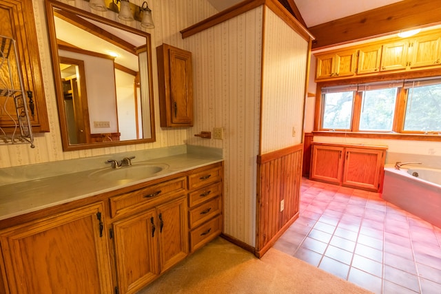 bathroom with a bathtub, tile flooring, lofted ceiling, and vanity