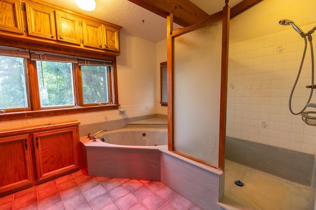 bathroom featuring tile flooring and separate shower and tub