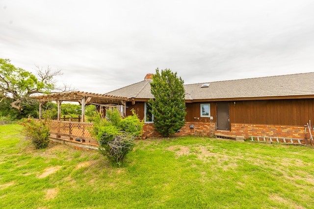 rear view of house with a pergola and a yard