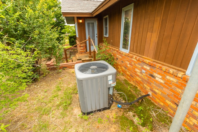 exterior details featuring wooden walls and central air condition unit