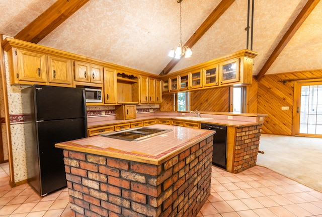 kitchen featuring a center island, black appliances, beam ceiling, and decorative light fixtures