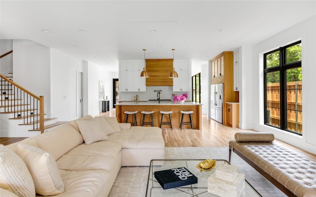 living room featuring sink and light wood-type flooring