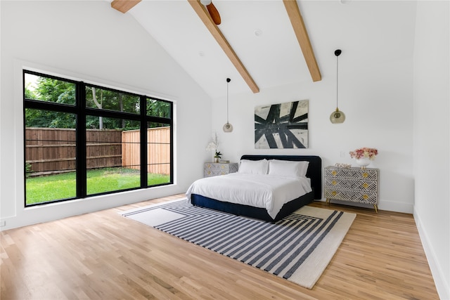 bedroom with high vaulted ceiling, beamed ceiling, and light hardwood / wood-style flooring