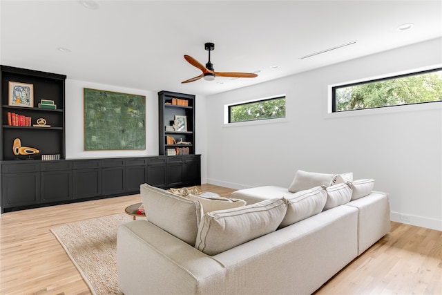 living room with light hardwood / wood-style flooring and ceiling fan