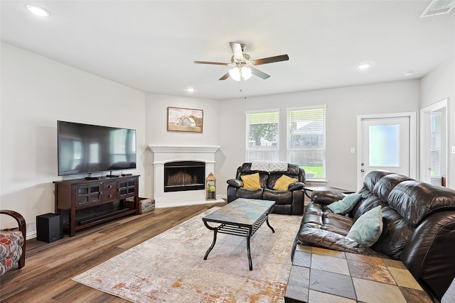 living room featuring ceiling fan and dark hardwood / wood-style flooring