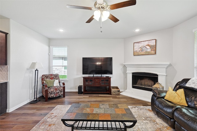 living room featuring dark wood-type flooring and ceiling fan