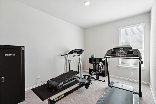 exercise room featuring plenty of natural light and light colored carpet