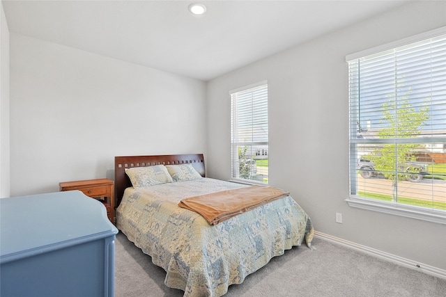 bedroom featuring light colored carpet