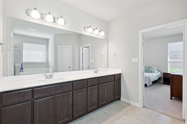 bathroom featuring tile patterned flooring and dual bowl vanity