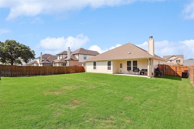 rear view of property with a patio and a yard