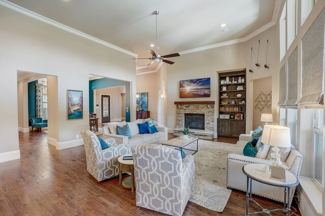 kitchen with white cabinets, a kitchen breakfast bar, a large island with sink, stainless steel built in fridge, and light stone counters