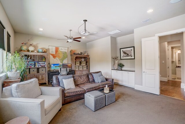 carpeted living room featuring ceiling fan