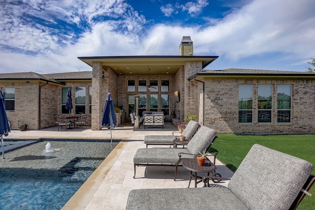 back of property with an outdoor hangout area and a patio area