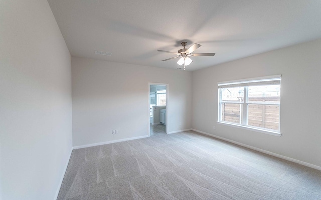 unfurnished room featuring light carpet, ceiling fan, and baseboards