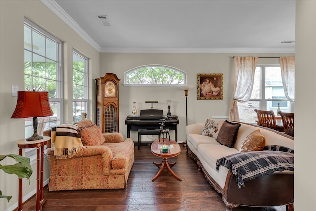 living room featuring ornamental molding, a healthy amount of sunlight, and dark wood-type flooring