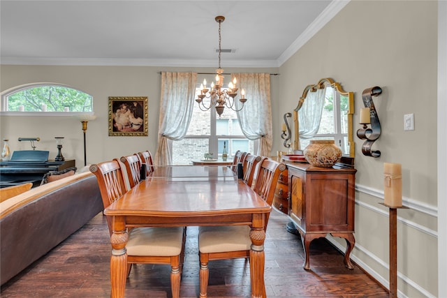 dining room featuring ornamental molding, an inviting chandelier, and dark hardwood / wood-style flooring