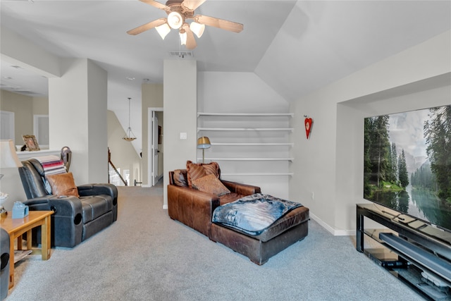 carpeted living room with vaulted ceiling and ceiling fan