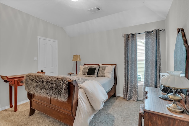 carpeted bedroom featuring lofted ceiling and multiple windows