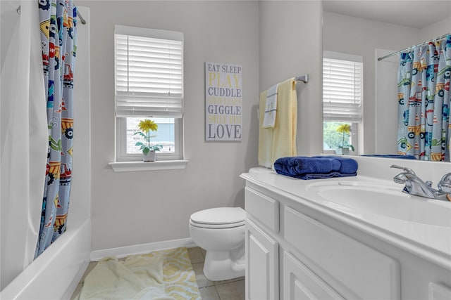 full bathroom featuring a healthy amount of sunlight, vanity with extensive cabinet space, toilet, and tile floors