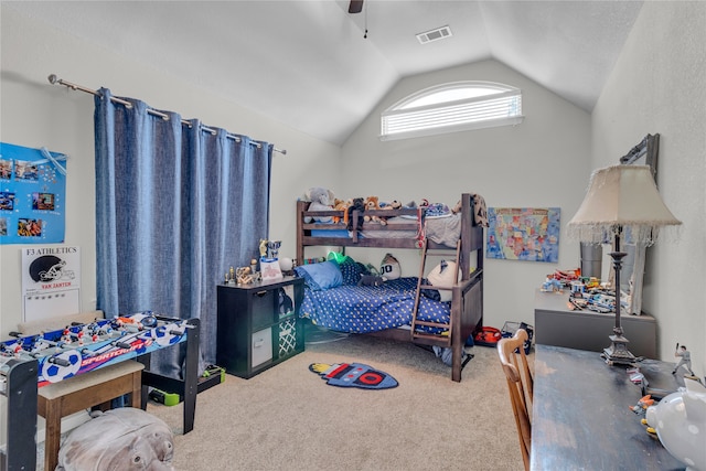 bedroom with ceiling fan, vaulted ceiling, and carpet floors