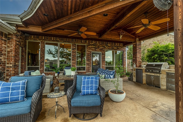 view of patio featuring exterior kitchen, ceiling fan, and grilling area