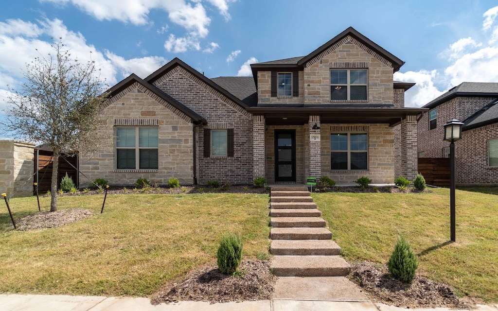 view of front of house featuring a porch, brick siding, stone siding, and a front lawn
