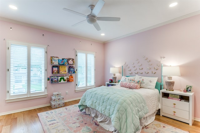 bedroom with ceiling fan, light hardwood / wood-style flooring, and multiple windows