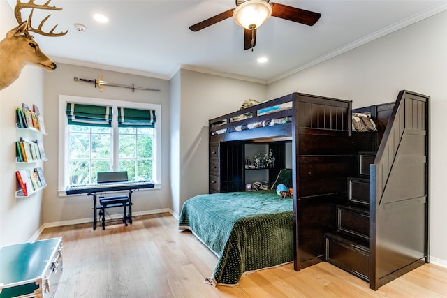 bedroom with ornamental molding, ceiling fan, and light wood-type flooring