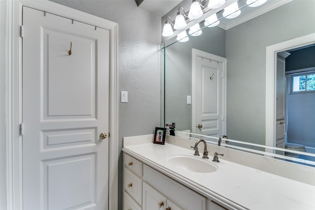 bathroom with ornamental molding and vanity