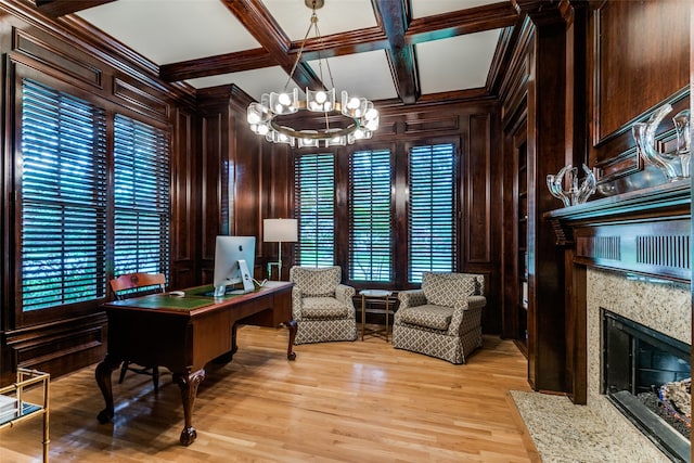 office with a healthy amount of sunlight, coffered ceiling, a high end fireplace, and light wood-type flooring