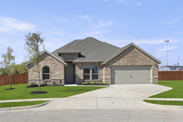 view of front facade with a front yard and a garage