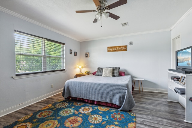 bedroom with ornamental molding, ceiling fan, and dark wood-type flooring