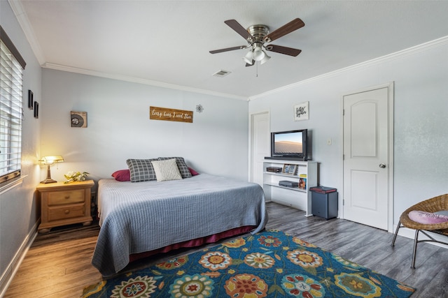 bedroom with ceiling fan, crown molding, and dark wood-type flooring