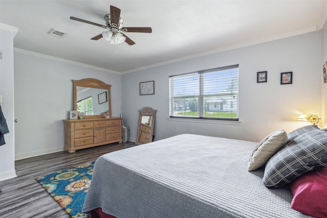 bedroom featuring multiple windows, ornamental molding, dark hardwood / wood-style floors, and ceiling fan