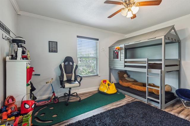 bedroom featuring ceiling fan, crown molding, and hardwood / wood-style floors