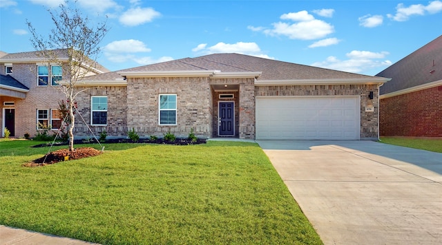 view of front of property with a garage and a front yard